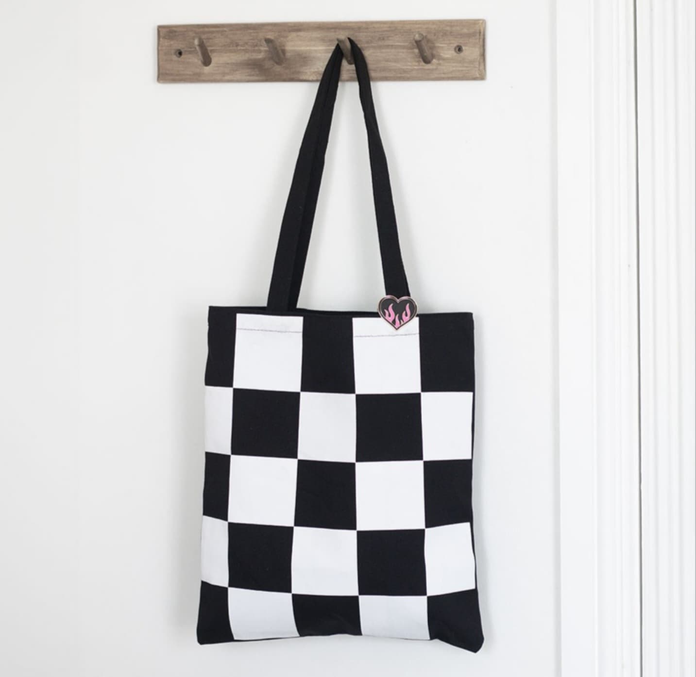 Checkerboard print tote bag with badge